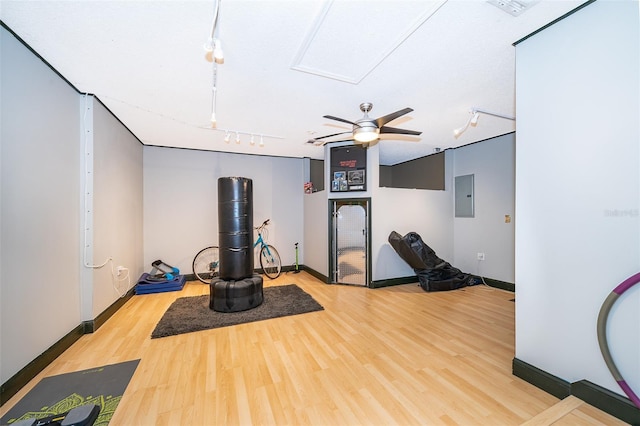 146 Hidden Pointe Ln, Groveland, FL 34736 - exercise area with rail lighting, electric panel, light wood-style flooring, and baseboards