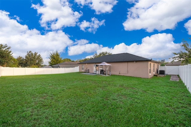 146 Hidden Pointe Ln, Groveland, FL 34736 - back of property featuring cooling unit, a gazebo, a patio area, and stucco siding
