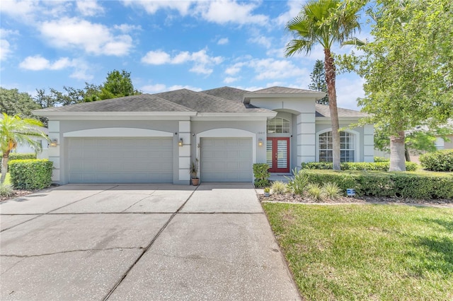 10417 Oakview Pointe Ter, Gotha, FL 34734 - view of front of property with an attached garage, stucco siding, driveway, a front lawn, and roof with shingles