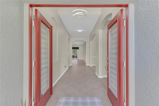 10417 Oakview Pointe Ter, Gotha, FL 34734 - hallway featuring arched walkways, a textured wall, and baseboards