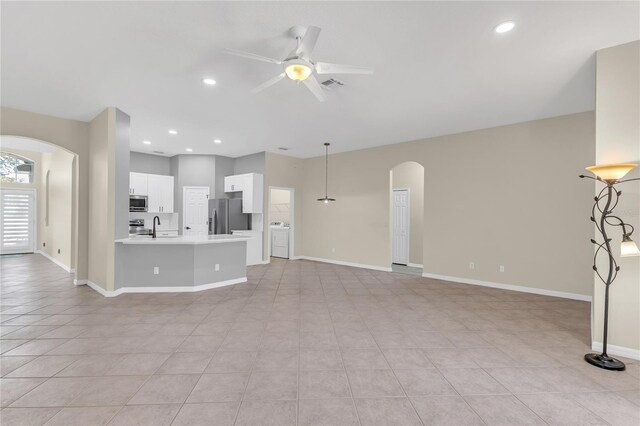 10417 Oakview Pointe Ter, Gotha, FL 34734 - unfurnished living room with arched walkways, a ceiling fan, a sink, baseboards, and recessed lighting