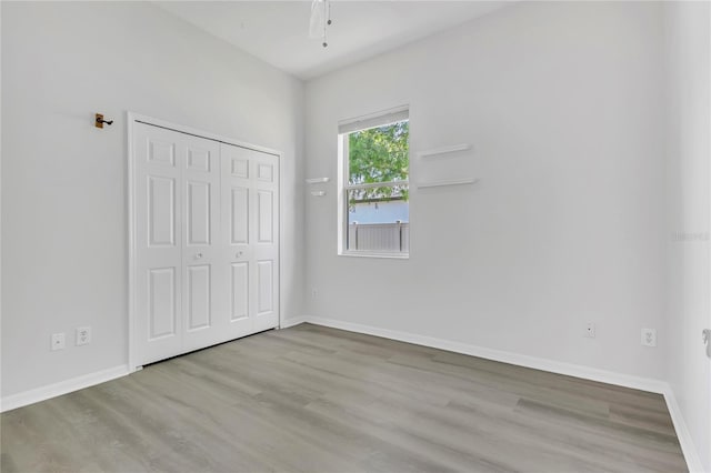10417 Oakview Pointe Ter, Gotha, FL 34734 - unfurnished bedroom featuring wood finished floors, baseboards, and a closet