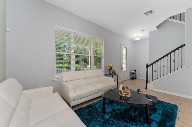 9348 Meadow Hunt Way, Winter Garden, FL 34787 - living area with stairway, wood finished floors, and baseboards