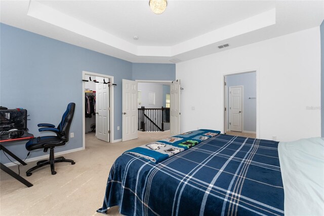 9348 Meadow Hunt Way, Winter Garden, FL 34787 - carpeted bedroom featuring a raised ceiling, a spacious closet, baseboards, a desk, and a closet
