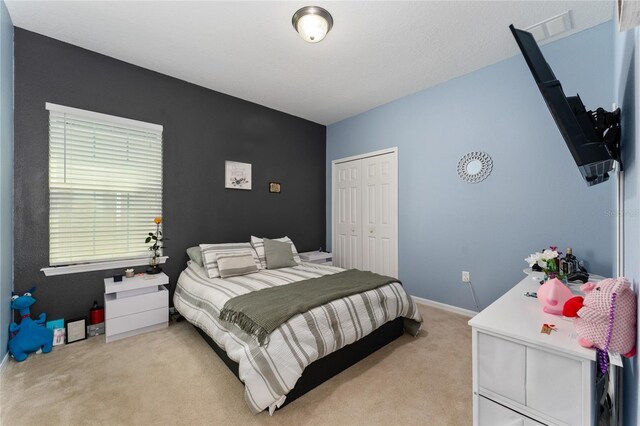9348 Meadow Hunt Way, Winter Garden, FL 34787 - bedroom featuring light colored carpet, a closet, and baseboards