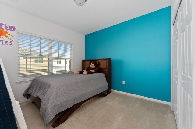 9348 Meadow Hunt Way, Winter Garden, FL 34787 - carpeted bedroom featuring a closet and baseboards