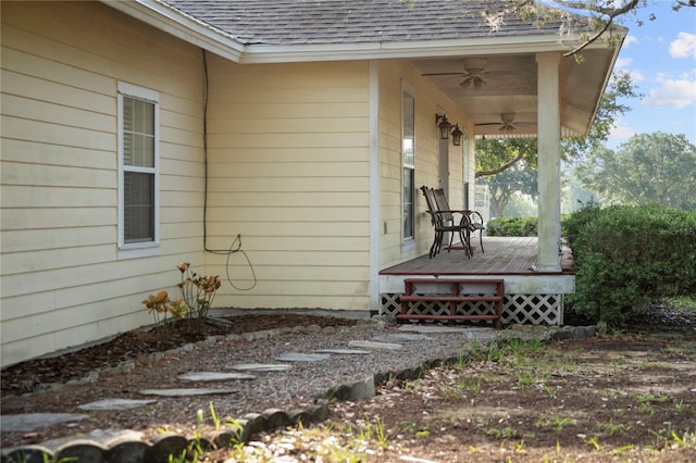 16017 Johns Lake Rd, Clermont, FL 34711 - view of side of property featuring ceiling fan, a shingled roof, and a wooden deck