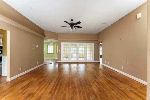 16017 Johns Lake Rd, Clermont, FL 34711 - unfurnished living room with a ceiling fan, baseboards, and wood finished floors