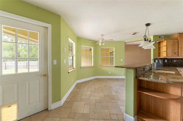 16017 Johns Lake Rd, Clermont, FL 34711 - kitchen with open shelves, a sink, baseboards, ceiling fan, and a textured ceiling