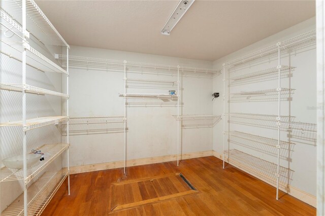 16017 Johns Lake Rd, Clermont, FL 34711 - spacious closet featuring wood finished floors