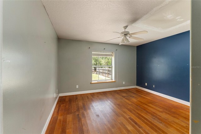 16017 Johns Lake Rd, Clermont, FL 34711 - empty room with a ceiling fan, hardwood / wood-style floors, baseboards, and a textured ceiling