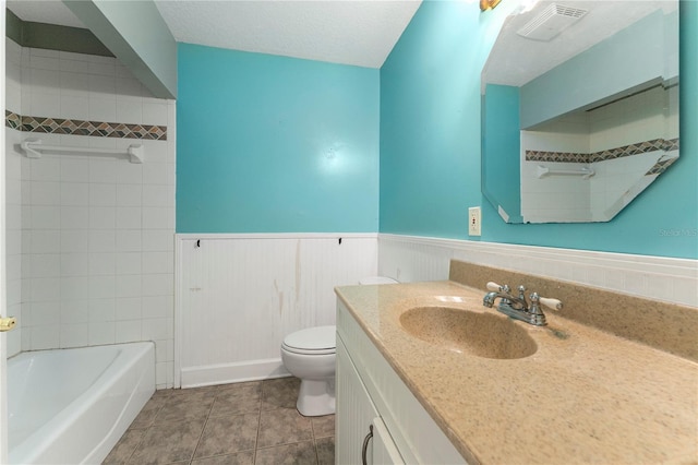16017 Johns Lake Rd, Clermont, FL 34711 - full bath with vanity, a wainscoted wall, toilet, and tile patterned floors