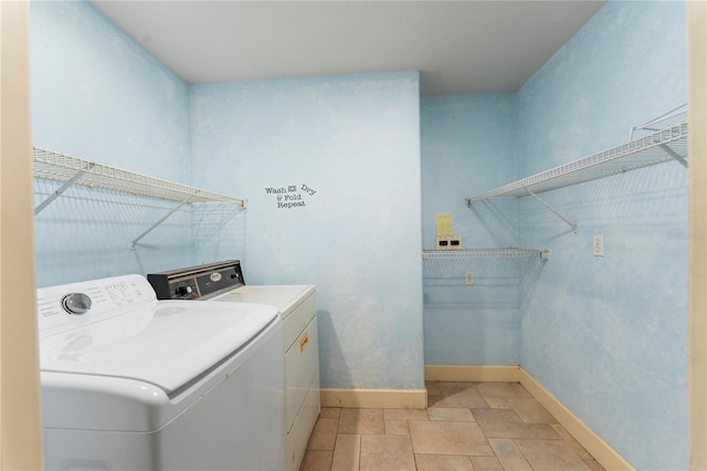 16017 Johns Lake Rd, Clermont, FL 34711 - washroom with washing machine and dryer, baseboards, and light stone finish floors