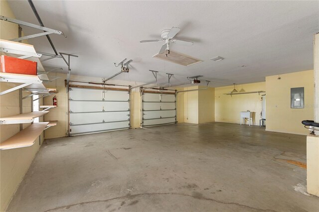 16017 Johns Lake Rd, Clermont, FL 34711 - garage with electric panel, a garage door opener, and a ceiling fan