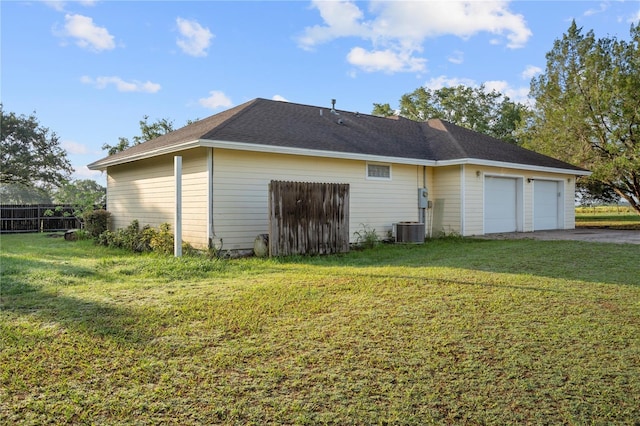 16017 Johns Lake Rd, Clermont, FL 34711 - rear view of house featuring central air condition unit, asphalt driveway, and an attached garage