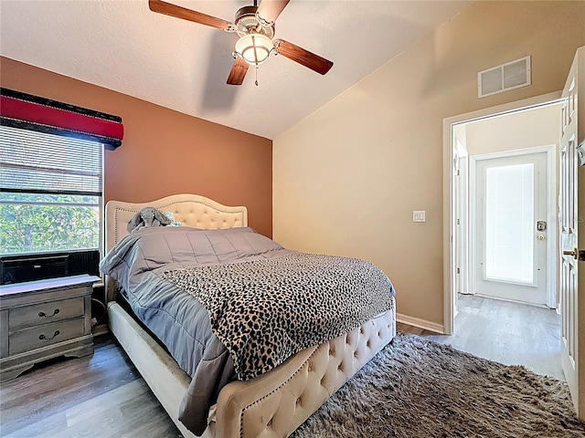 1913 Blue River Rd, Holiday, FL 34691 - bedroom with lofted ceiling, wood finished floors, and ceiling fan