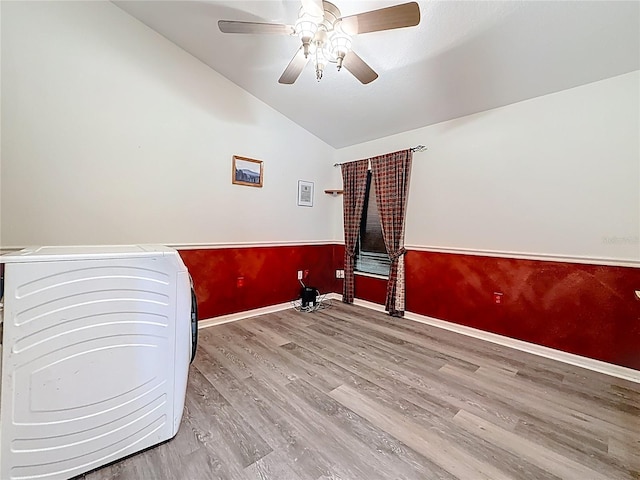 1913 Blue River Rd, Holiday, FL 34691 - empty room featuring washer / dryer, lofted ceiling, wood finished floors, ceiling fan, and baseboards