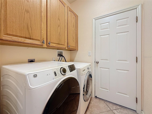 1913 Blue River Rd, Holiday, FL 34691 - laundry room featuring cabinet space, washing machine and clothes dryer, and light tile patterned floors