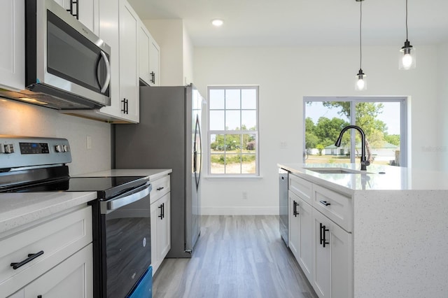 3211 SW 128th Street Rd, Ocala, FL 34473 - kitchen featuring stainless steel appliances, a sink, healthy amount of natural light, light wood-style floors, and recessed lighting