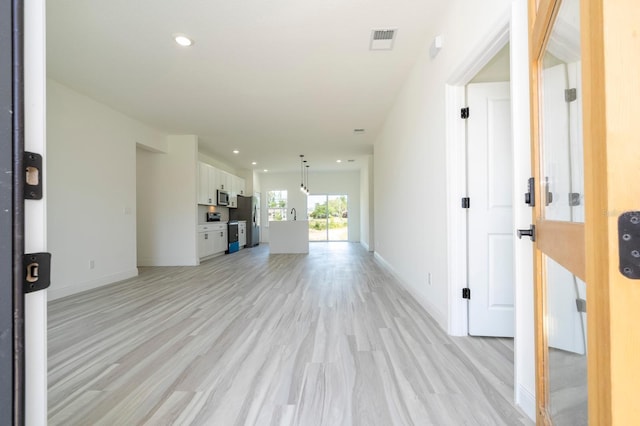 3211 SW 128th Street Rd, Ocala, FL 34473 - unfurnished living room featuring light wood-style floors, baseboards, and recessed lighting