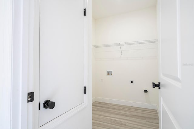 3211 SW 128th Street Rd, Ocala, FL 34473 - laundry room featuring hookup for an electric dryer, washer hookup, light wood-style flooring, and baseboards