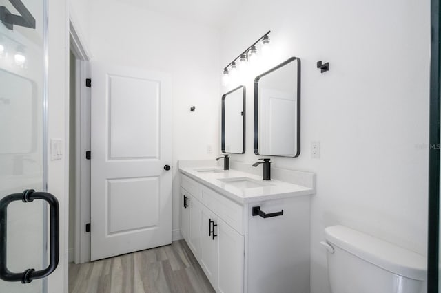3211 SW 128th Street Rd, Ocala, FL 34473 - full bath featuring wood finished floors, double vanity, and toilet