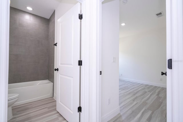 3211 SW 128th Street Rd, Ocala, FL 34473 - full bathroom with toilet, wood finished floors, baseboards, recessed lighting, and washtub / shower combination
