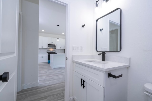 3211 SW 128th Street Rd, Ocala, FL 34473 - bathroom featuring vanity, wood finished floors, recessed lighting, toilet, and baseboards