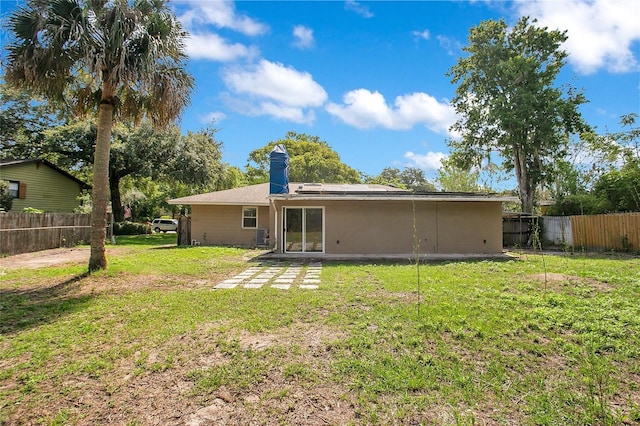 3431 Hunt Ln, Oviedo, FL 32765 - back of property featuring a chimney, solar panels, and a patio