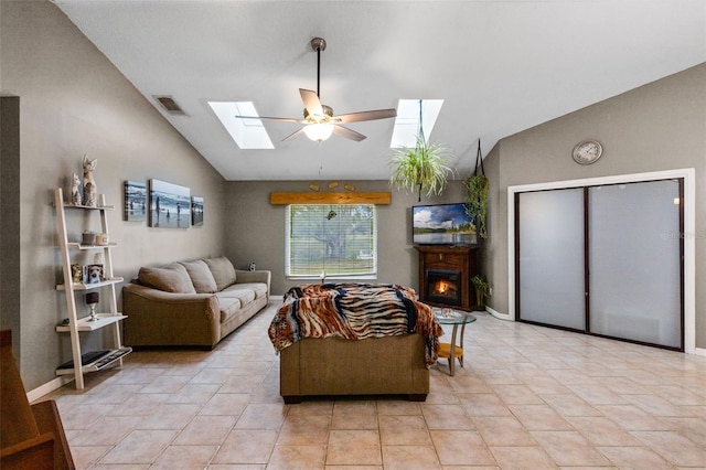 2916 Maldive Ct, Deltona, FL 32738 - living area with a skylight, lofted ceiling, ceiling fan, a warm lit fireplace, and light tile patterned floors