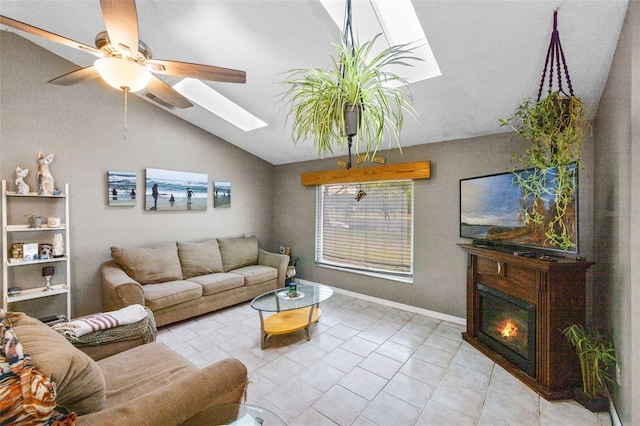 2916 Maldive Ct, Deltona, FL 32738 - tiled living room featuring a skylight, vaulted ceiling, ceiling fan, and a glass covered fireplace