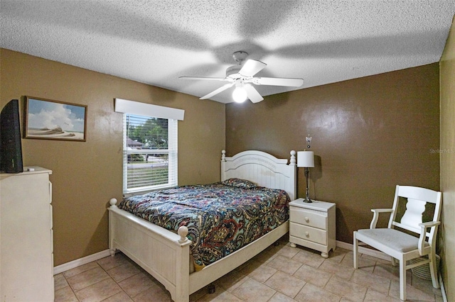 2916 Maldive Ct, Deltona, FL 32738 - bedroom featuring light tile patterned floors, baseboards, ceiling fan, and a textured ceiling