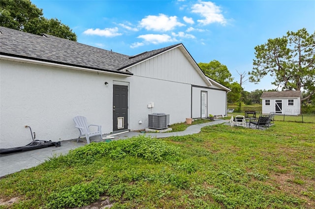 2916 Maldive Ct, Deltona, FL 32738 - back of property with a yard, central AC, an outdoor structure, and a shingled roof
