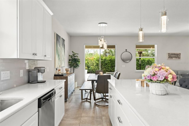 2401 Oxmoor Dr, Deland, FL 32724 - kitchen featuring dishwasher, backsplash, light countertops, and white cabinets