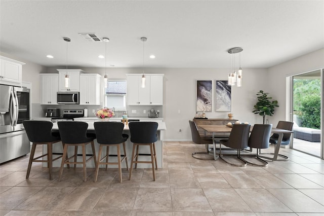 2401 Oxmoor Dr, Deland, FL 32724 - kitchen featuring stainless steel appliances, plenty of natural light, light countertops, a kitchen island, and recessed lighting
