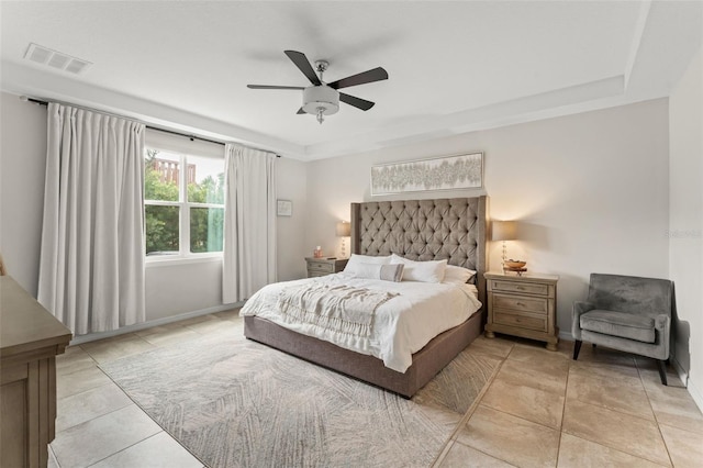 2401 Oxmoor Dr, Deland, FL 32724 - bedroom with light tile patterned floors, a ceiling fan, baseboards, and a tray ceiling