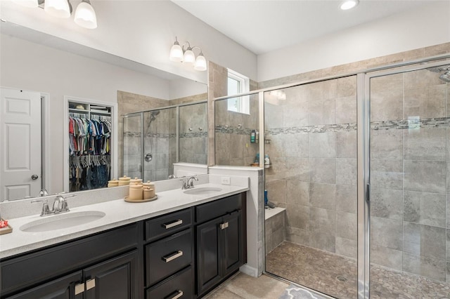 2401 Oxmoor Dr, Deland, FL 32724 - bathroom with a shower stall, double vanity, a spacious closet, and tile patterned floors