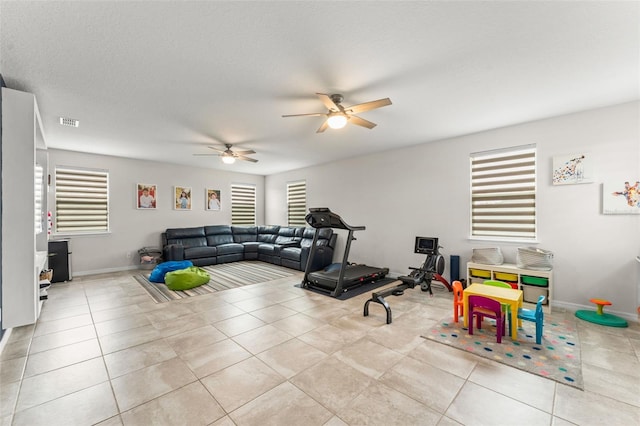 2401 Oxmoor Dr, Deland, FL 32724 - workout area featuring a ceiling fan, tile patterned flooring, and baseboards