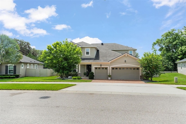 2401 Oxmoor Dr, Deland, FL 32724 - view of front of property featuring driveway, an attached garage, stucco siding, and a shingled roof