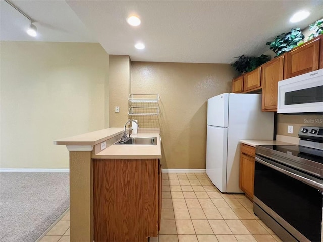 4010 Santa Maria Dr Unit 106, Kissimmee, FL 34741 - kitchen featuring white appliances, a sink, brown cabinetry, light countertops, and light tile patterned floors