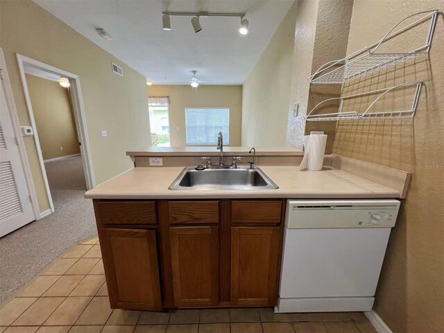 4010 Santa Maria Dr Unit 106, Kissimmee, FL 34741 - kitchen with white dishwasher, a sink, a ceiling fan, light countertops, and light tile patterned floors