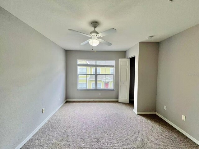 4010 Santa Maria Dr Unit 106, Kissimmee, FL 34741 - unfurnished bedroom featuring carpet, baseboards, and a ceiling fan
