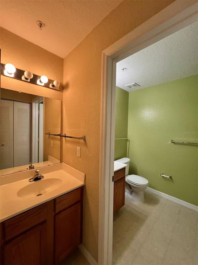 4010 Santa Maria Dr Unit 106, Kissimmee, FL 34741 - bathroom with vanity, a textured wall, toilet, a textured ceiling, and tile patterned floors