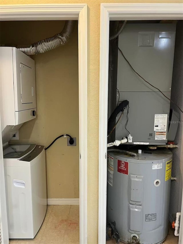 4010 Santa Maria Dr Unit 106, Kissimmee, FL 34741 - laundry area featuring stacked washer and clothes dryer and baseboards
