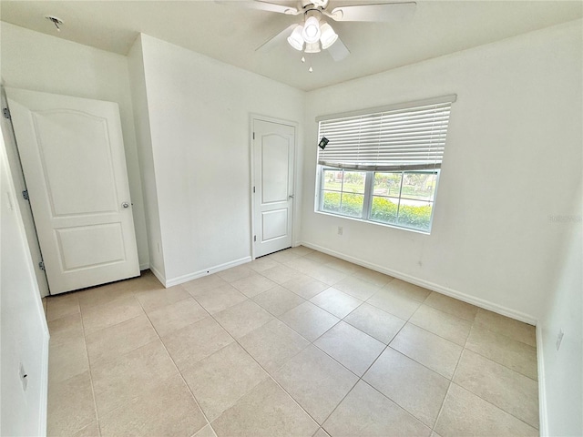 238 Miniehaha Cir, Haines City, FL 33844 - unfurnished bedroom featuring light tile patterned floors, baseboards, and ceiling fan