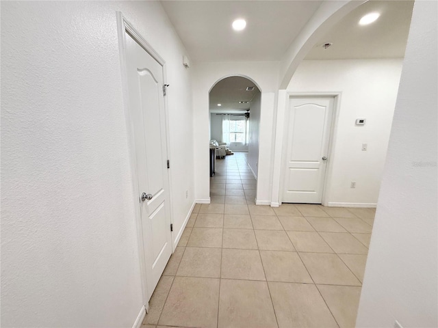 238 Miniehaha Cir, Haines City, FL 33844 - corridor with light tile patterned floors, arched walkways, recessed lighting, and baseboards