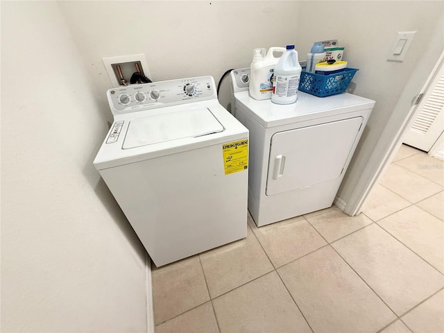 238 Miniehaha Cir, Haines City, FL 33844 - washroom with washer and clothes dryer and light tile patterned floors
