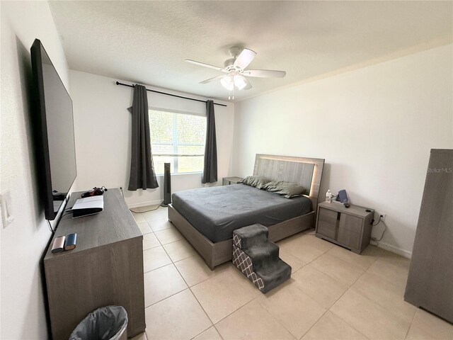 238 Miniehaha Cir, Haines City, FL 33844 - bedroom featuring light tile patterned floors, a ceiling fan, and baseboards