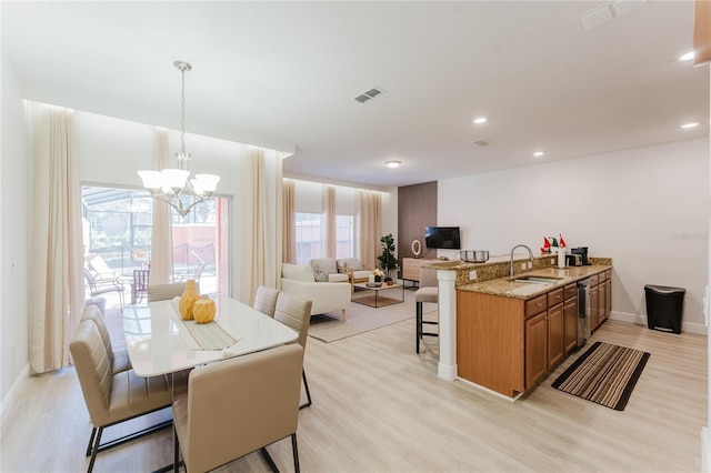 2923 Banana Palm Dr, Kissimmee, FL 34747 - dining space featuring light wood-style floors, a chandelier, baseboards, and recessed lighting