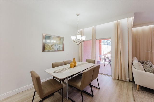 2923 Banana Palm Dr, Kissimmee, FL 34747 - dining area with a chandelier, light wood-type flooring, and baseboards